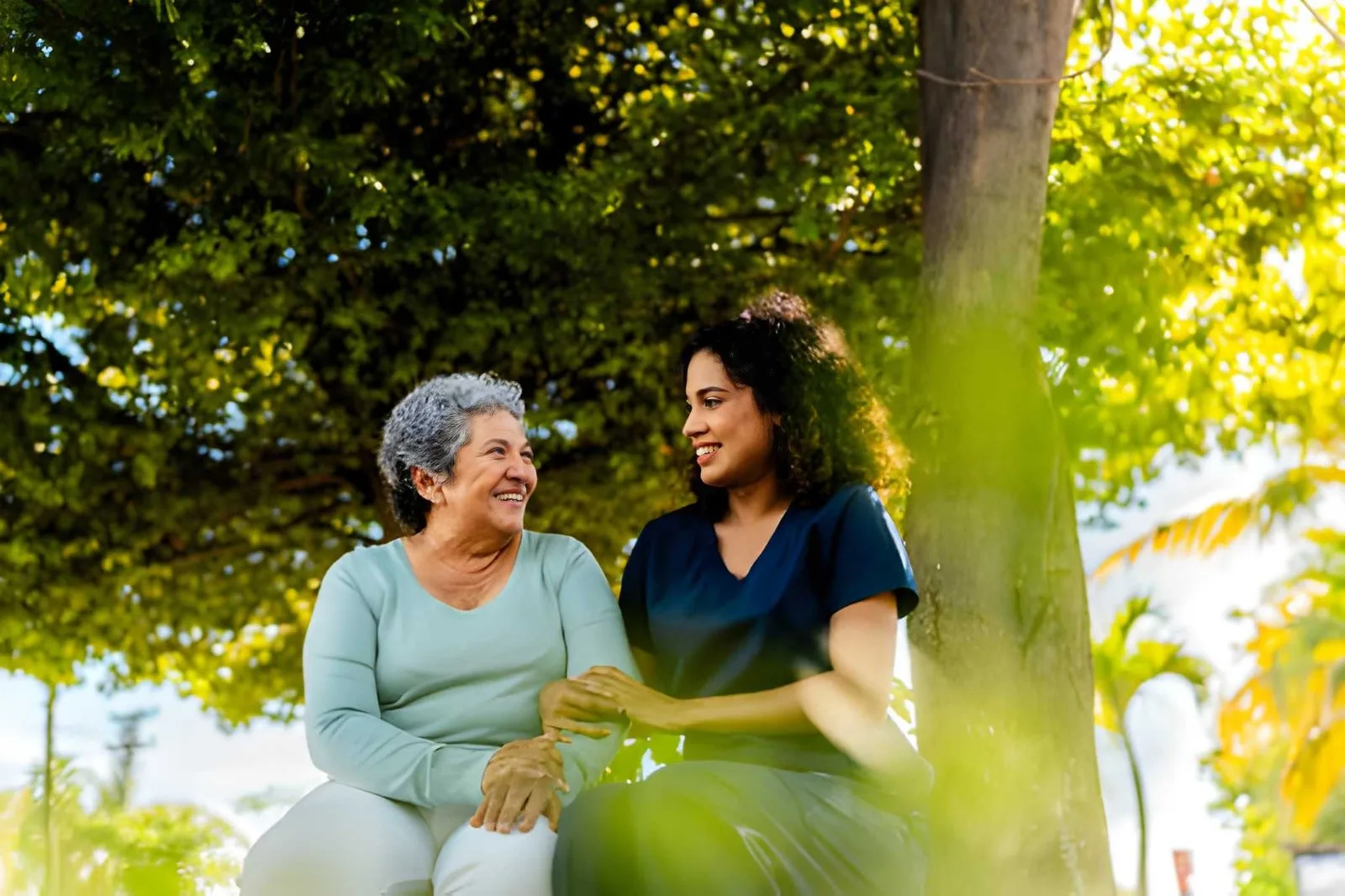 Caregiver and older adult enjoying time outdoors together
